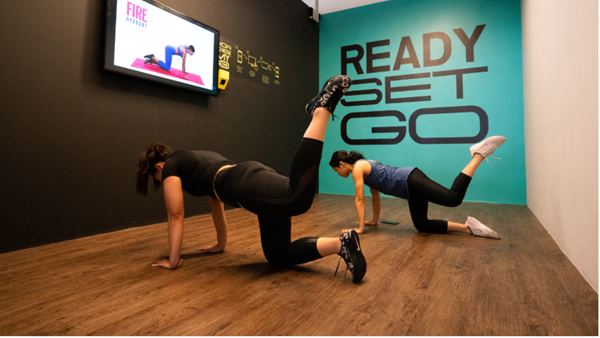 Two people doing the donkey kick at GoFit i-City